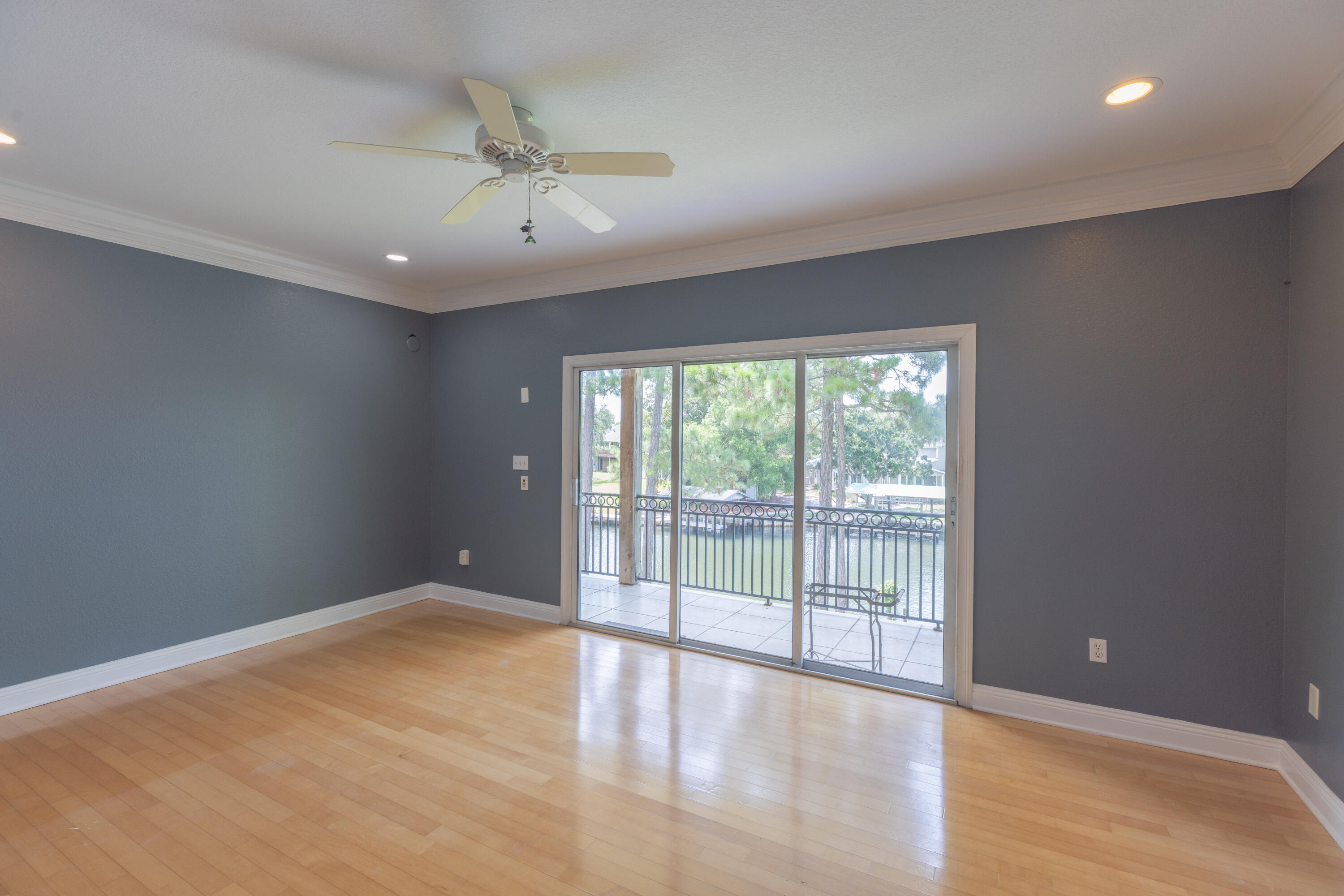 4561 Soundside Terrace Gulf Breeze, FL 32563 - Photo 15 of 35 an empty room with wooden floor and windows