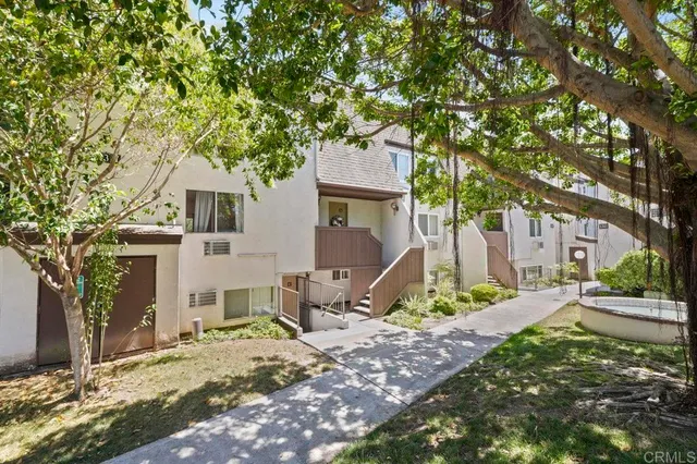 a house that has a tree in front of it