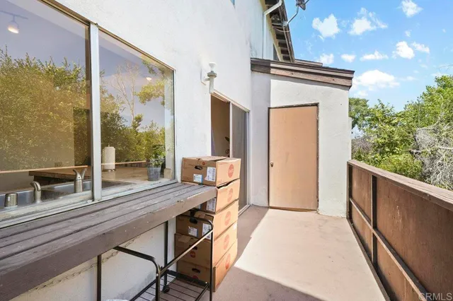a view of balcony with furniture and garden