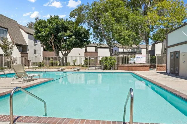 a swimming pool with outdoor seating and yard