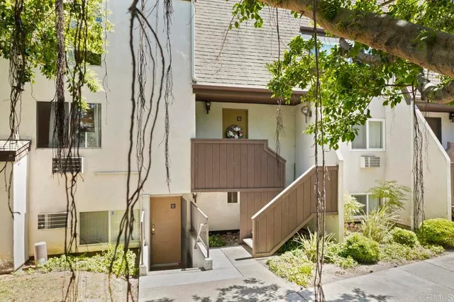 a front view of a house with plants