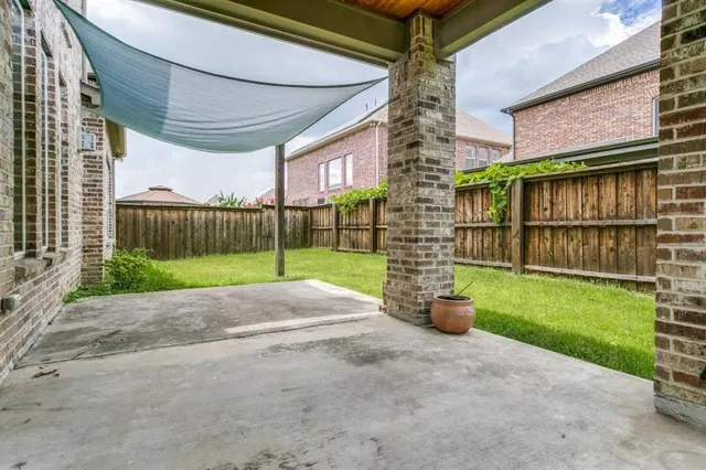 a view of a chair and table in the patio