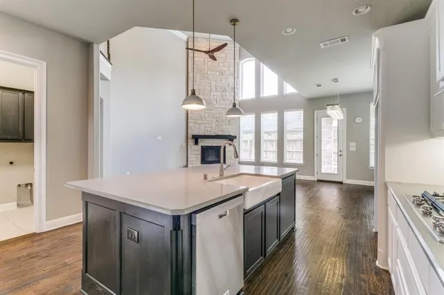 a kitchen with a sink a large window and stainless steel appliances