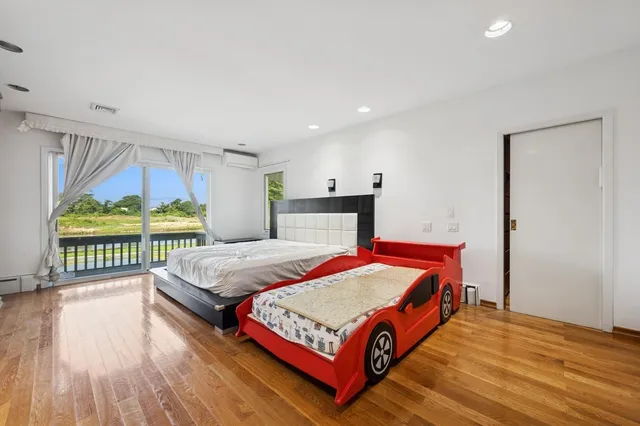 a bedroom with a bed and a large window