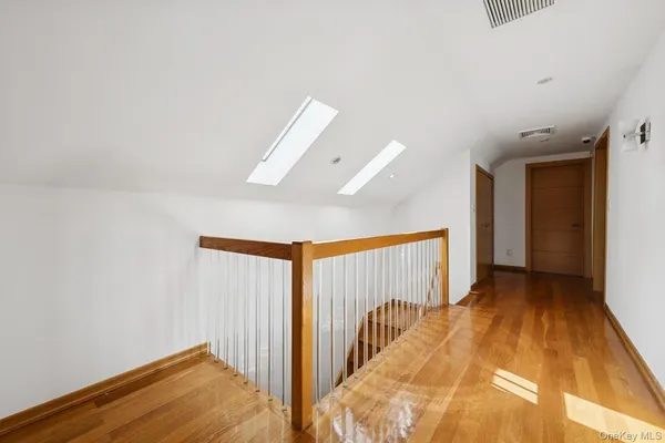 a view of hallway with wooden floor