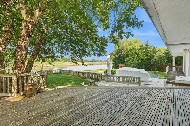 a view of a terrace with wooden floor and fence