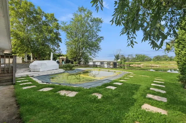 a backyard of a house with table and chairs