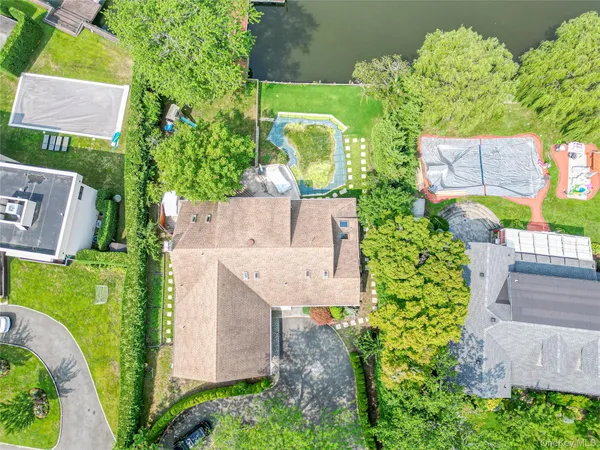 an aerial view of a house with a yard basket ball court and outdoor seating