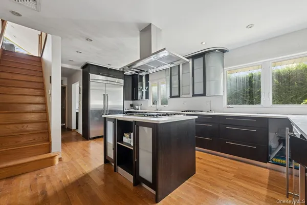 a kitchen with granite countertop a sink cabinets and stainless steel appliances