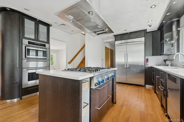a kitchen with stainless steel appliances granite countertop a stove and a refrigerator