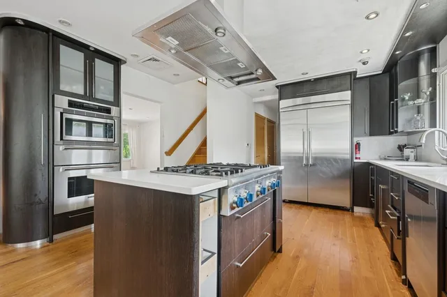 a kitchen with stainless steel appliances granite countertop a stove and a refrigerator