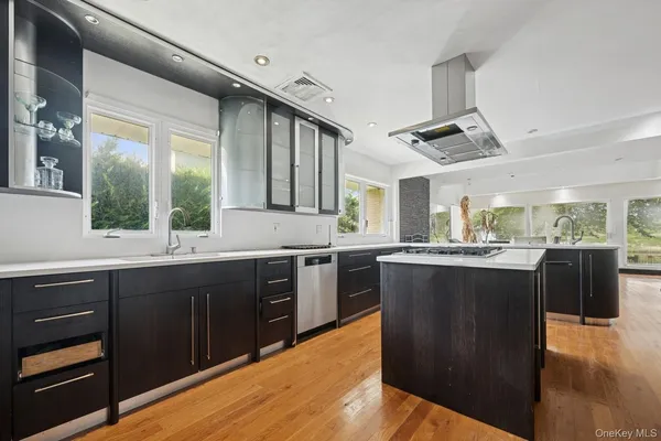 a large kitchen with wooden cabinets and stainless steel appliances