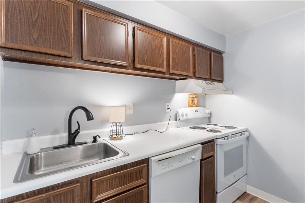 329 Ridge Point Circle, Unit 33 Bridgeville, PA 15017 - Photo 11 of 32 a kitchen with stainless steel appliances granite countertop a sink a stove and cabinets