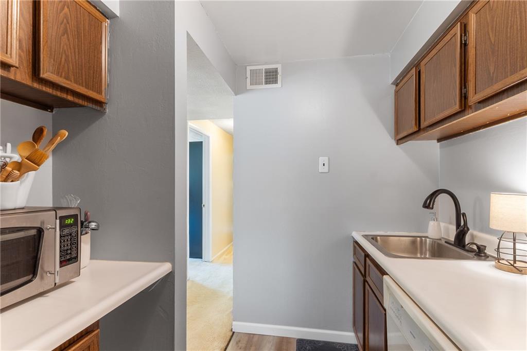 329 Ridge Point Circle, Unit 33 Bridgeville, PA 15017 - Photo 12 of 32 a kitchen with stainless steel appliances granite countertop a sink and a microwave
