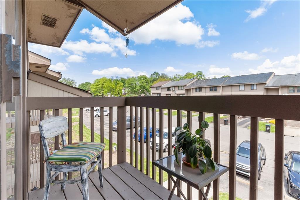 329 Ridge Point Circle, Unit 33 Bridgeville, PA 15017 - Photo 19 of 32 a view of a balcony with chairs and wooden floor