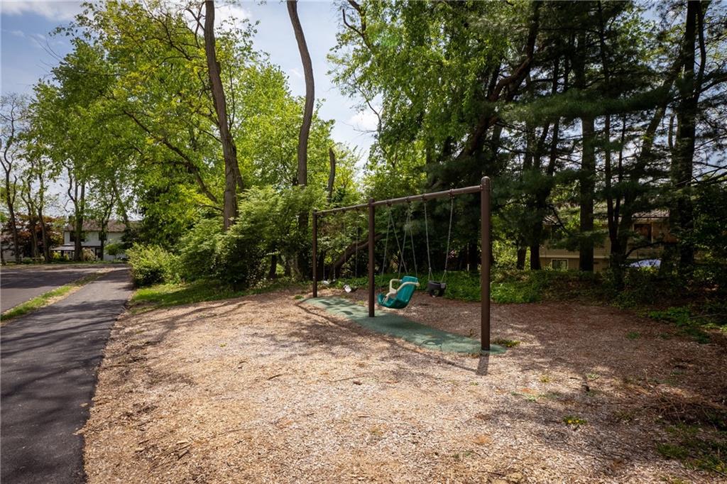 329 Ridge Point Circle, Unit 33 Bridgeville, PA 15017 - Photo 26 of 32 a backyard of a house with lots of trees