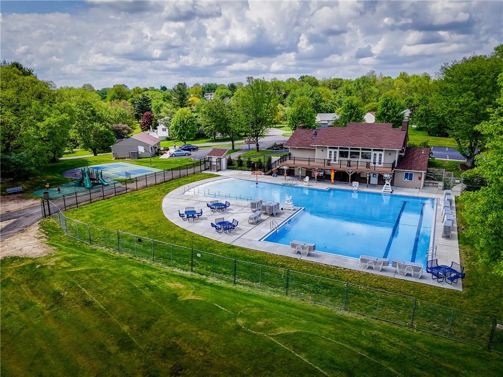 329 Ridge Point Circle, Unit 33 Bridgeville, PA 15017 - Photo 30 of 32 a view of a swimming pool with lawn chairs and a big yard