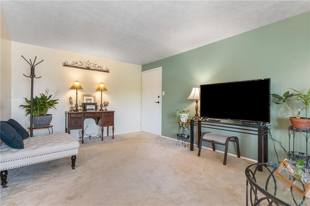 329 Ridge Point Circle, Unit 33 Bridgeville, PA 15017 - Photo 5 of 32 a living room with furniture and a flat screen tv