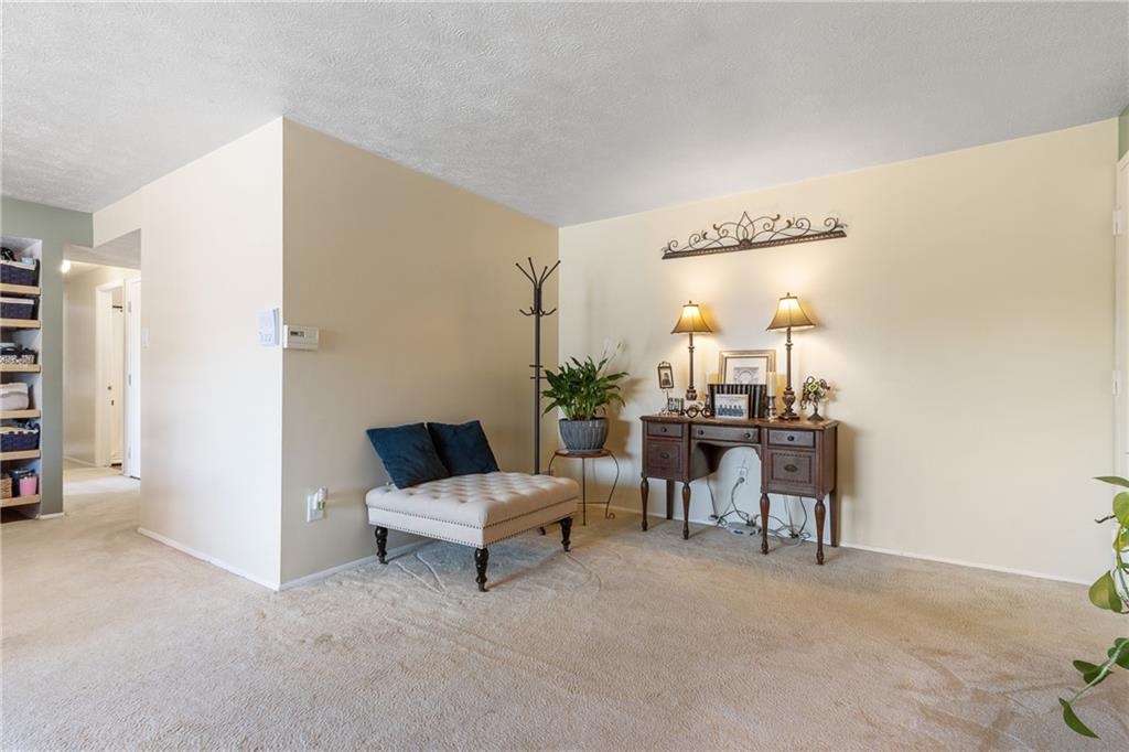 329 Ridge Point Circle, Unit 33 Bridgeville, PA 15017 - Photo 10 of 32 a living room with furniture and a table