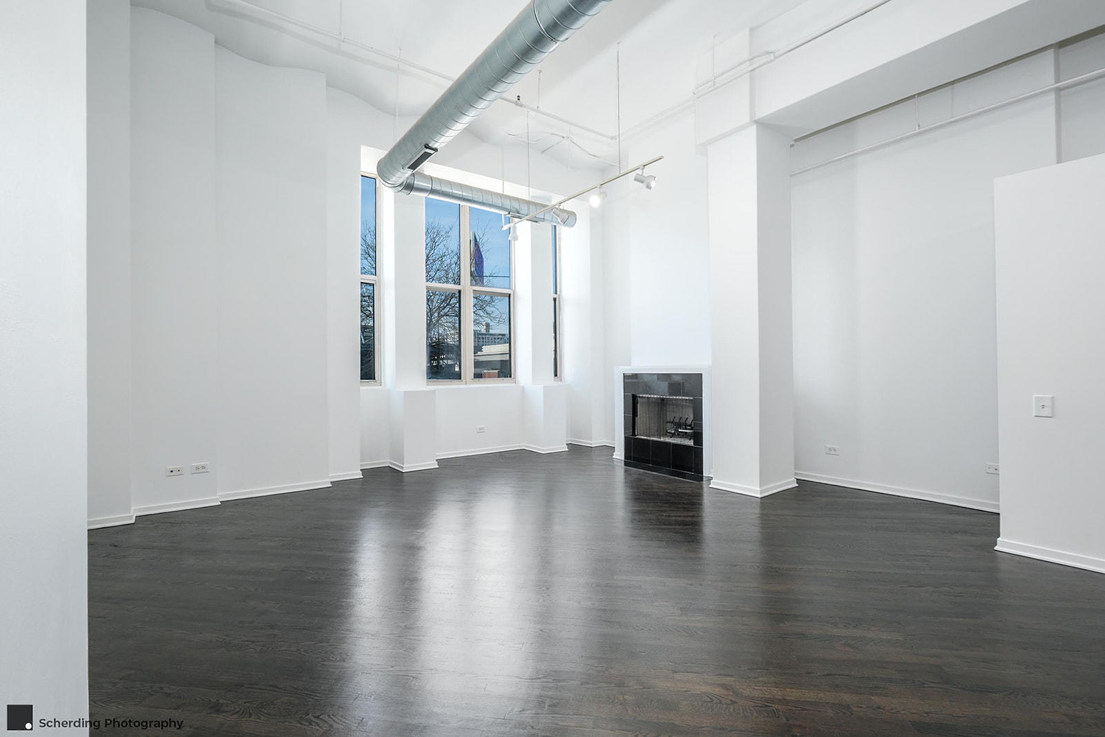 500 South Clinton Street, Unit 130 Chicago, IL 60607 - Photo 8 of 17 an empty room with wooden floor and windows