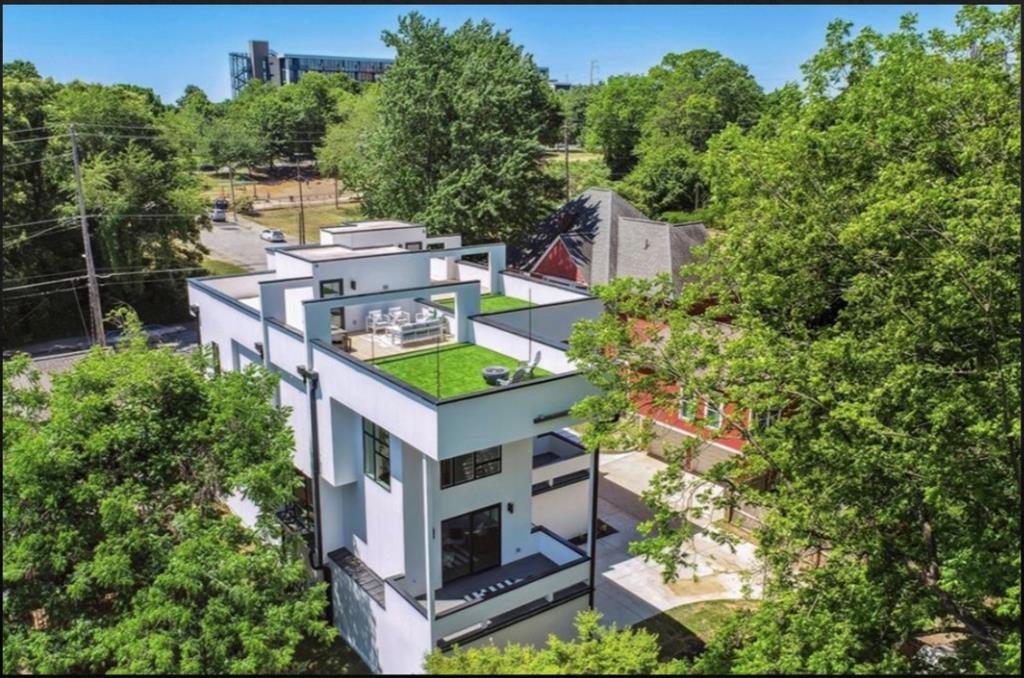 an aerial view of residential house with outdoor space and trees around