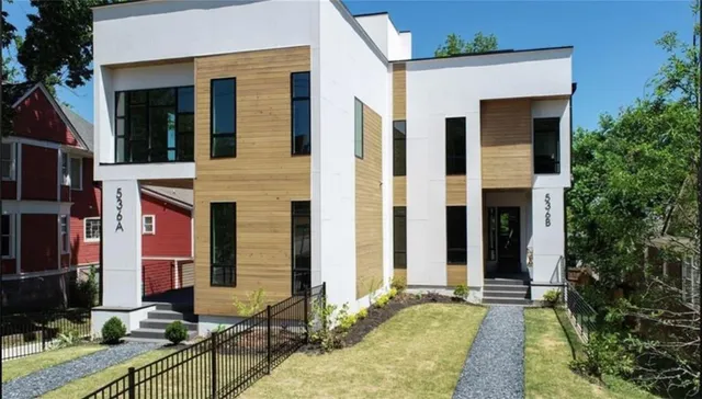 an aerial view of residential house with outdoor space and trees around