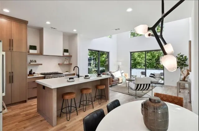a kitchen with a sink a counter top space and living room