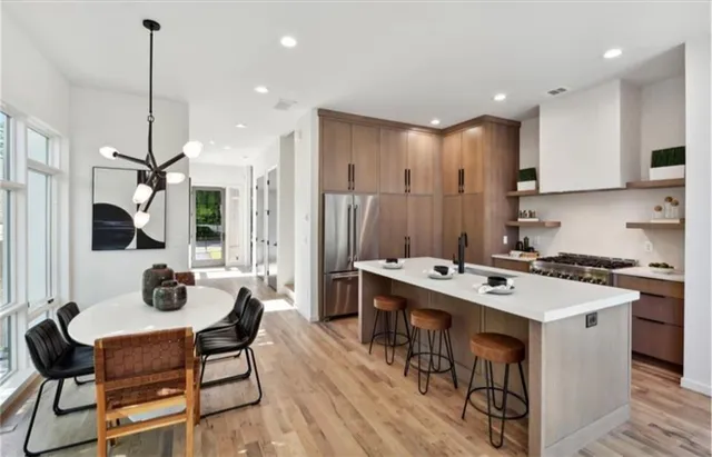 a kitchen with a sink stainless steel appliances and furniture
