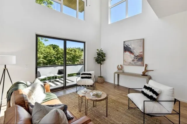 a living room with furniture and a floor to ceiling window