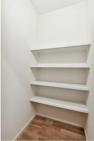 a work place with couch and wooden floor