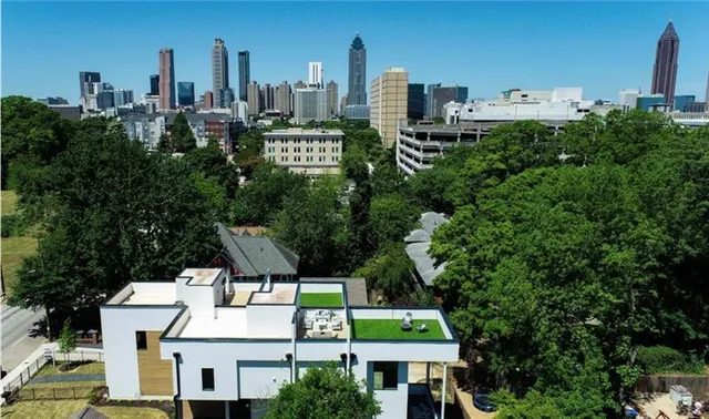 a row of palm trees in front of house