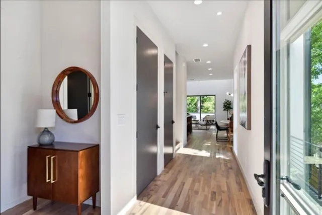 a living room with furniture and a painting on the wall