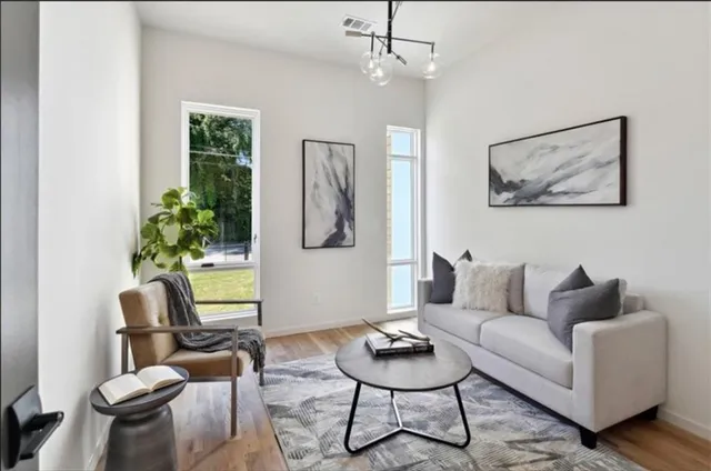 a kitchen with a sink a stove a refrigerator and chairs