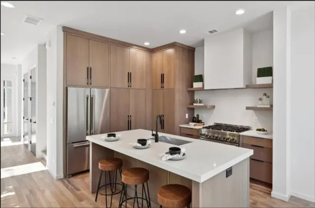 a kitchen with a table chairs stove and refrigerator