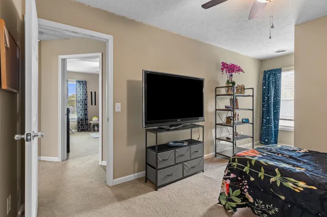 a bedroom with furniture and a flat tv screen