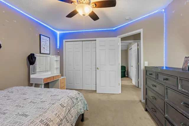 a bedroom with a bed and a chandelier