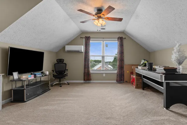 a view of a livingroom with furniture and a flat screen tv
