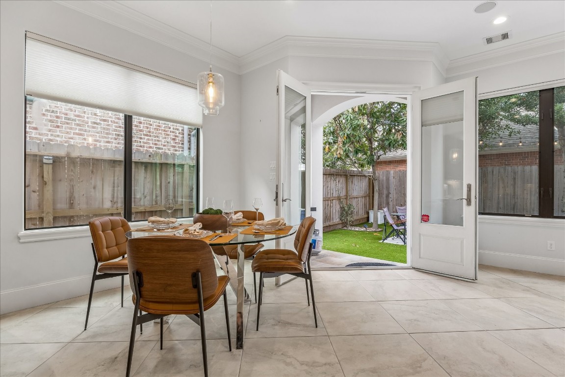 4022 Coleridge Street Houston, TX 77005 - Photo 12 of 31 Light-filled breakfast nook with modern lighting and French doors opening to the private backyard patio.