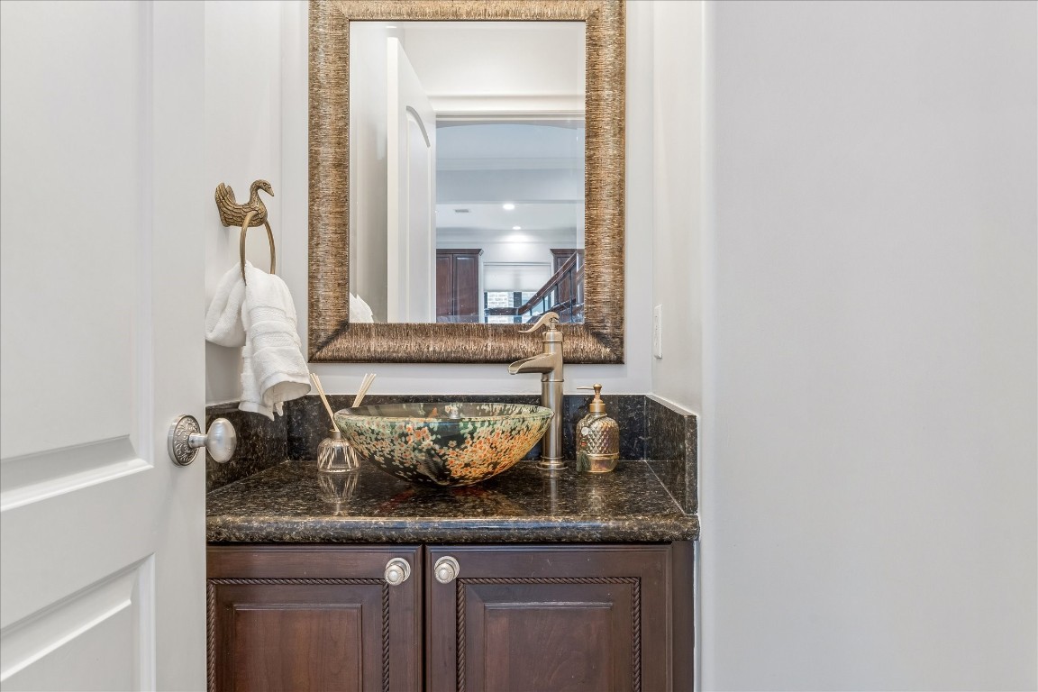4022 Coleridge Street Houston, TX 77005 - Photo 13 of 31 Stylish powder bath featuring a decorative vessel sink, granite counter, and designer fixtures.