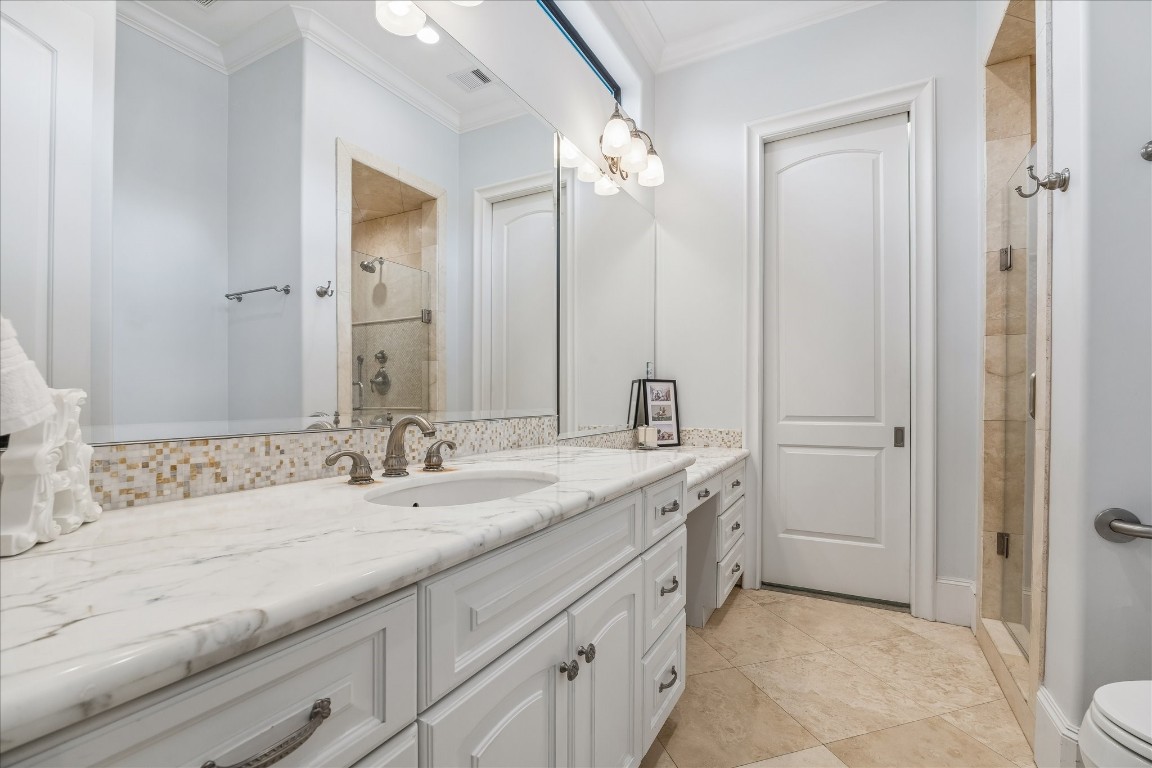4022 Coleridge Street Houston, TX 77005 - Photo 15 of 31 Ensuite bathroom to the junior suite on first floor with walk-in shower, marble counter-tops and lots of storage space.