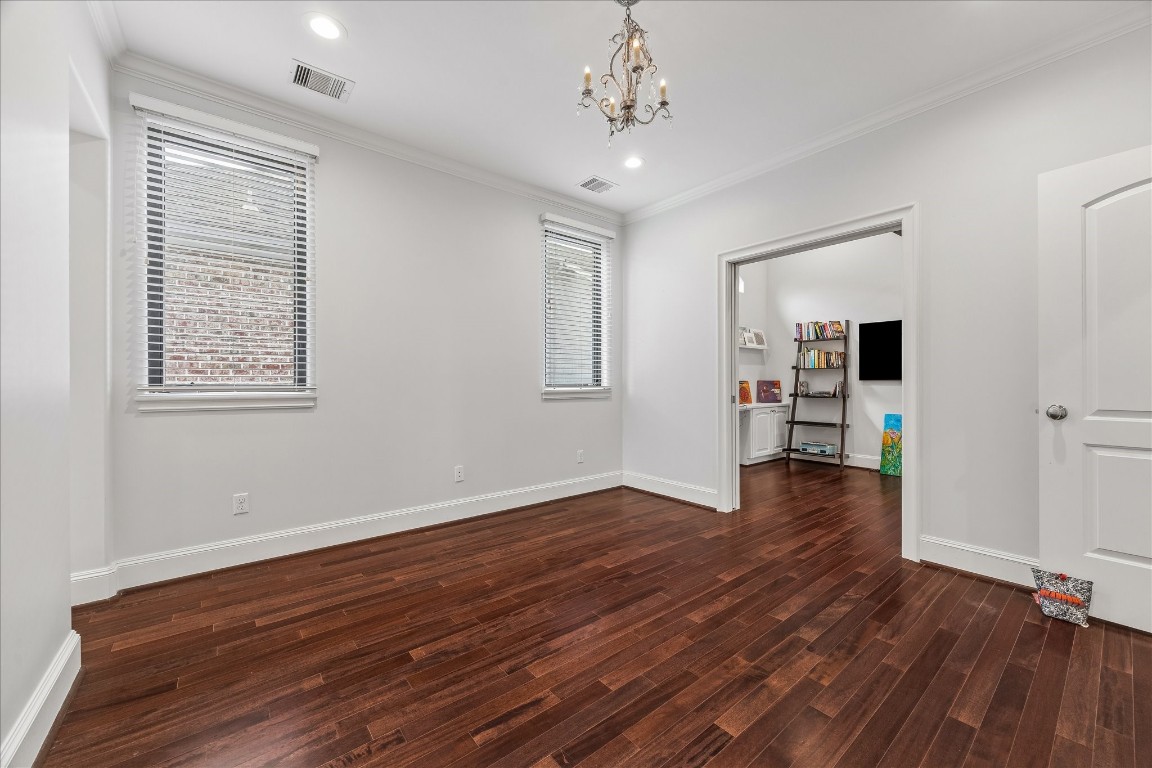 4022 Coleridge Street Houston, TX 77005 - Photo 19 of 31 Bright secondary bedroom with hardwood flooring, large windows, and ample space for guests or family.