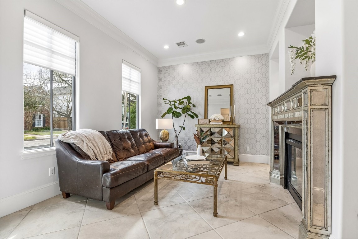 4022 Coleridge Street Houston, TX 77005 - Photo 2 of 31 Elegant formal living area with fireplace, crown molding, recessed lighting, and front-facing windows creating a cozy retreat.