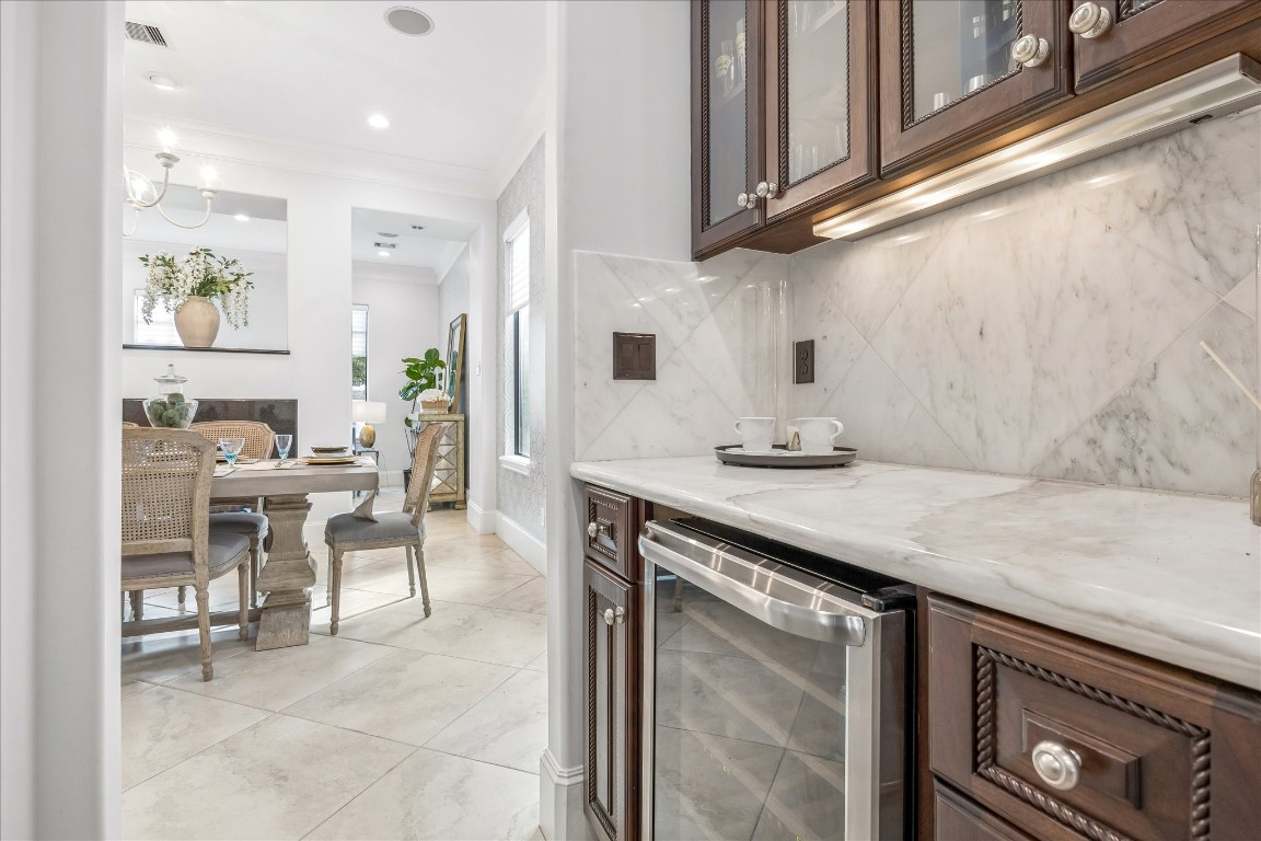 4022 Coleridge Street Houston, TX 77005 - Photo 5 of 31 Built-in beverage refrigerator with coffee station. Marble backsplash and countertops complete with wine storage. Perfect for entertaining and hosting events.