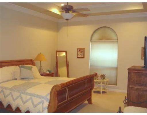 a bedroom with a bed and a chair