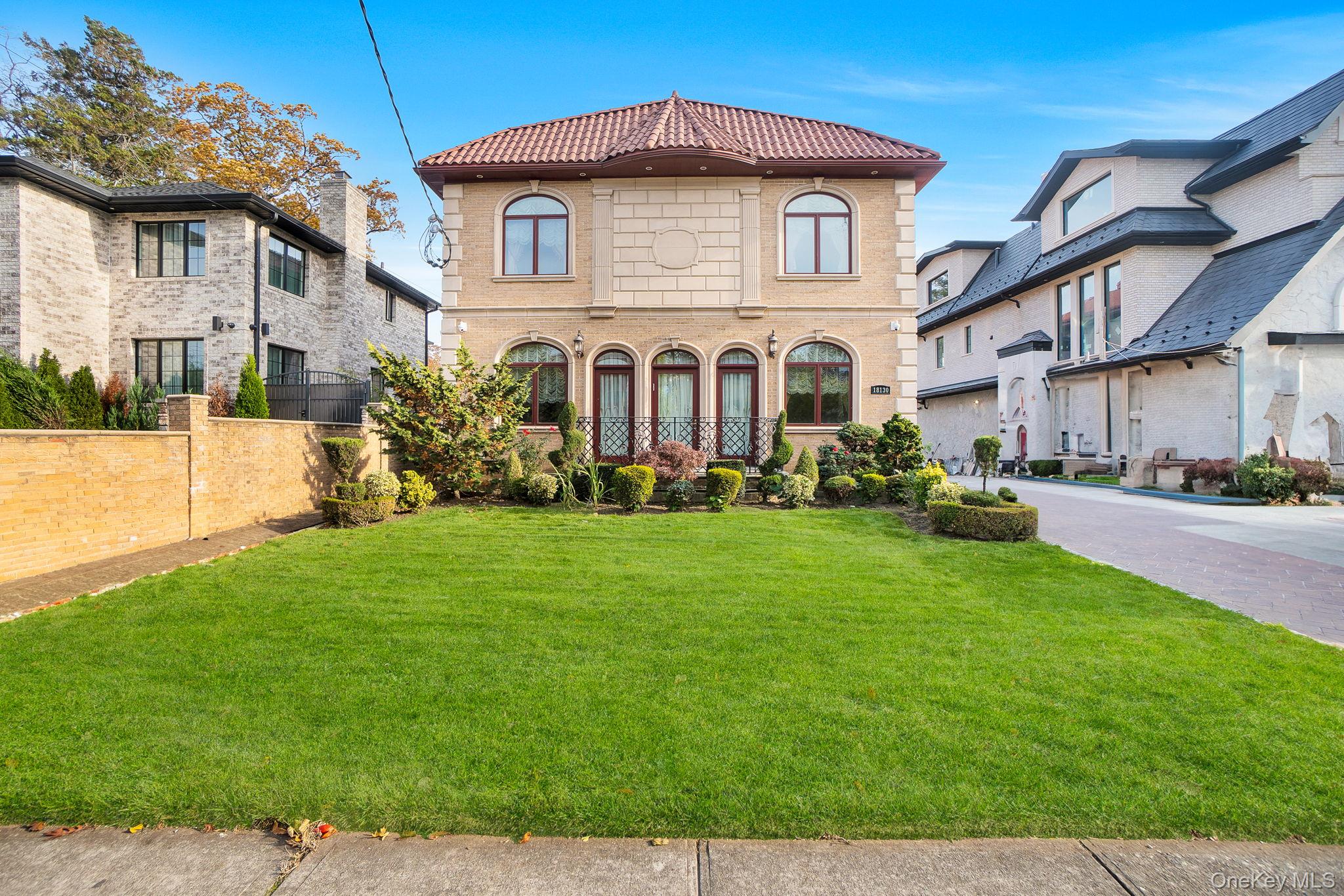181-30 Tudor Road Queens, NY 11432 - Photo 1 of 46 View of front facade featuring a tiled roof and driveway
