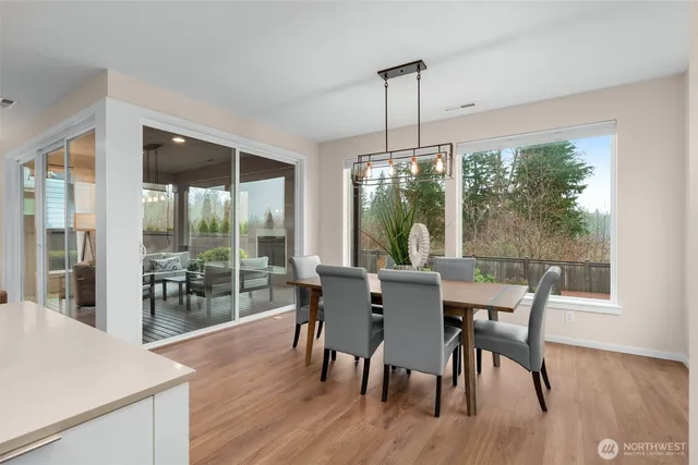 a view of a dining room with furniture window and wooden floor