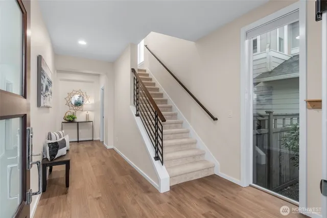 a view of entryway and hall with wooden floor