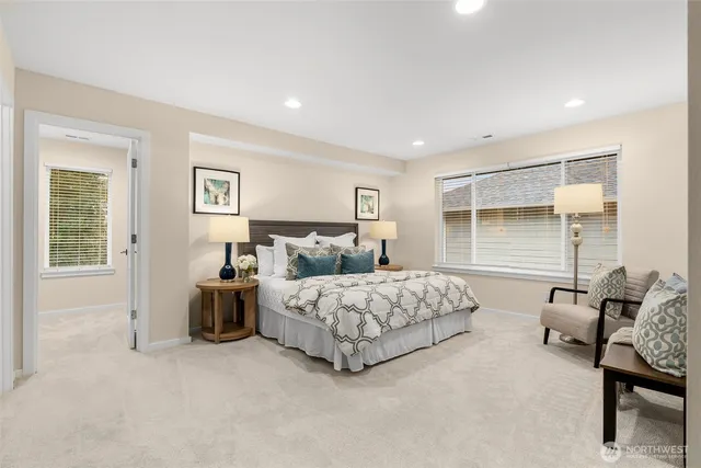 a spacious bedroom with a bed and glass window