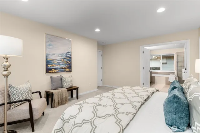 a bedroom with a large bed and a chandelier