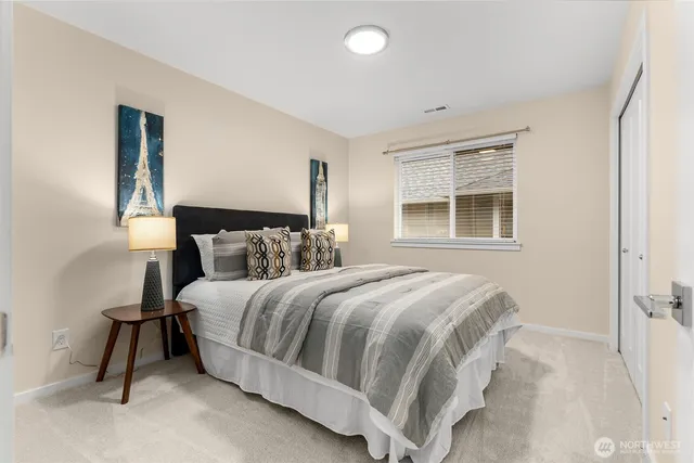 a bedroom with a bed and a window